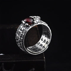 PiXiu Red Garnet Wealth Ring – Angled view of PiXiu figure atop red garnet gemstone, wealth coin pattern