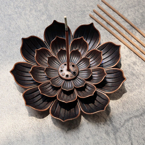 Six-Hole Lotus Incense Burner with burning stick, antique bronze petals on gray stone Hauptbild