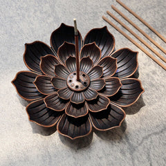 Six-Hole Lotus Incense Burner with burning stick, antique bronze petals on gray stone
