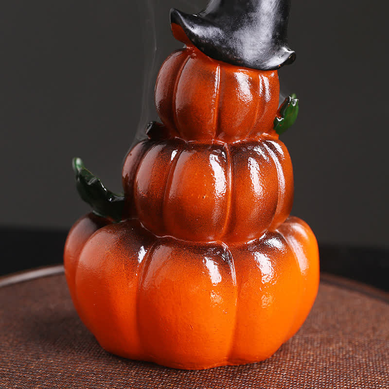 Triple-stacked pumpkin incense burner with witch hat, green leaves, smoke trail, dark backdrop – Halloween ceramic incense holder