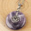 Crystal Amethyst Pink Crystal Lotus Necklace – Purple amethyst donut pendant with lotus overlay on wood, close-up spiritual jewelry