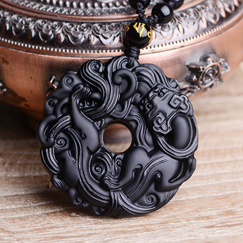 Black Obsidian Pixiu Pendant – Close-up by antique bronze bowl, black beaded cord detail