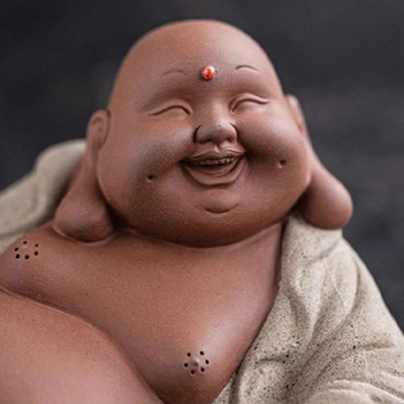Laughing Buddha Clay Statue – gold painted accents on purple clay surface, hand-finished details