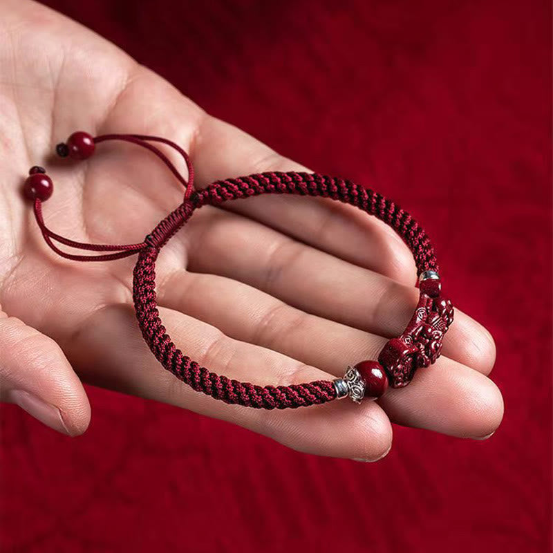 Handcrafted PiXiu Cinnabar Wealth Luck Braided Bracelet – adjustable bracelet resting in open palm, size view