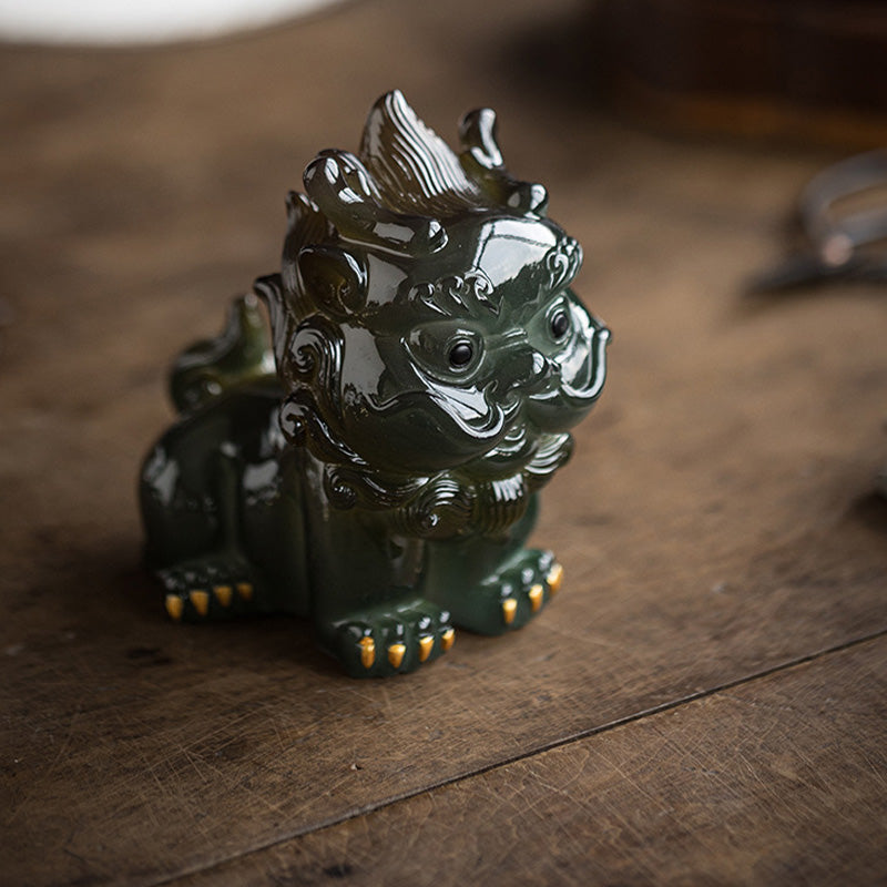 Small PiXiu Tea Pet – Dark green PiXiu on wooden table surface, moody wealth home figurine