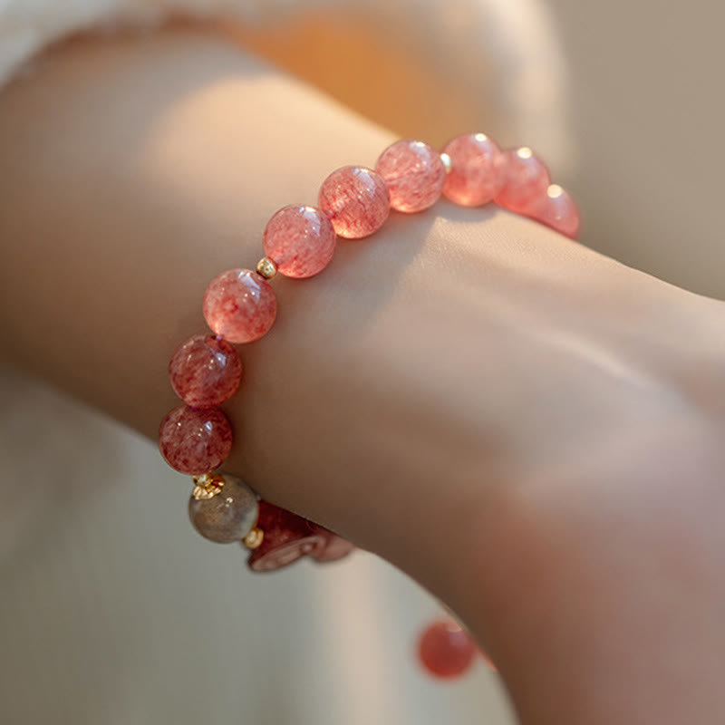Strawberry Quartz Moonstone Bracelet – wrist close-up pink bead texture gold accents, love healing bracelet