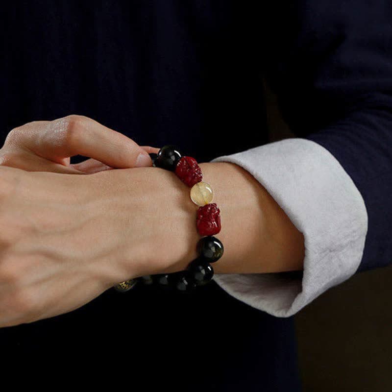 Gold Sheen Obsidian Pixiu Bracelet – wrist side angle with white cuff, adjusting cinnabar pixiu and obsidian beads