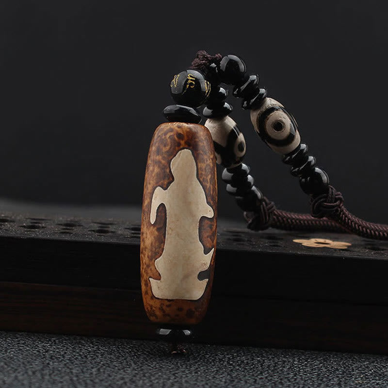 Dzi Bead Necklace – Avalokitesvara figure carved on brown agate with gold-accented mantra bead, protective