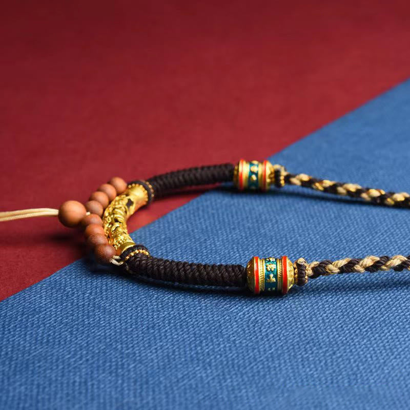 Tibetan King Kong Knot Prayer Wheel Necklace – braided cord detail with gold centerpiece, handmade necklace