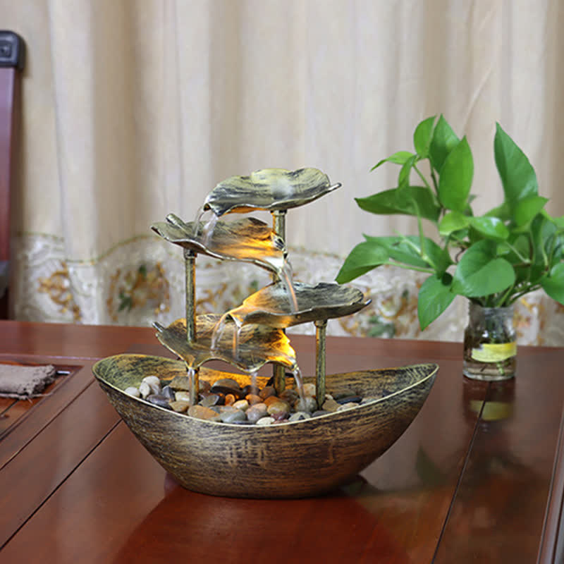 Lotus Leaf LED Waterfall Fountain - illuminated bronze cascade beside curtains and plant, relaxation decor