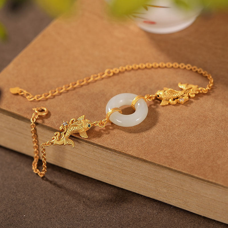 White Jade Koi Bracelet – close-up of single carved koi fish bead with detailed fin and tail texture