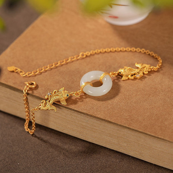 White Jade Koi Bracelet – close-up of single carved koi fish bead with detailed fin and tail texture
