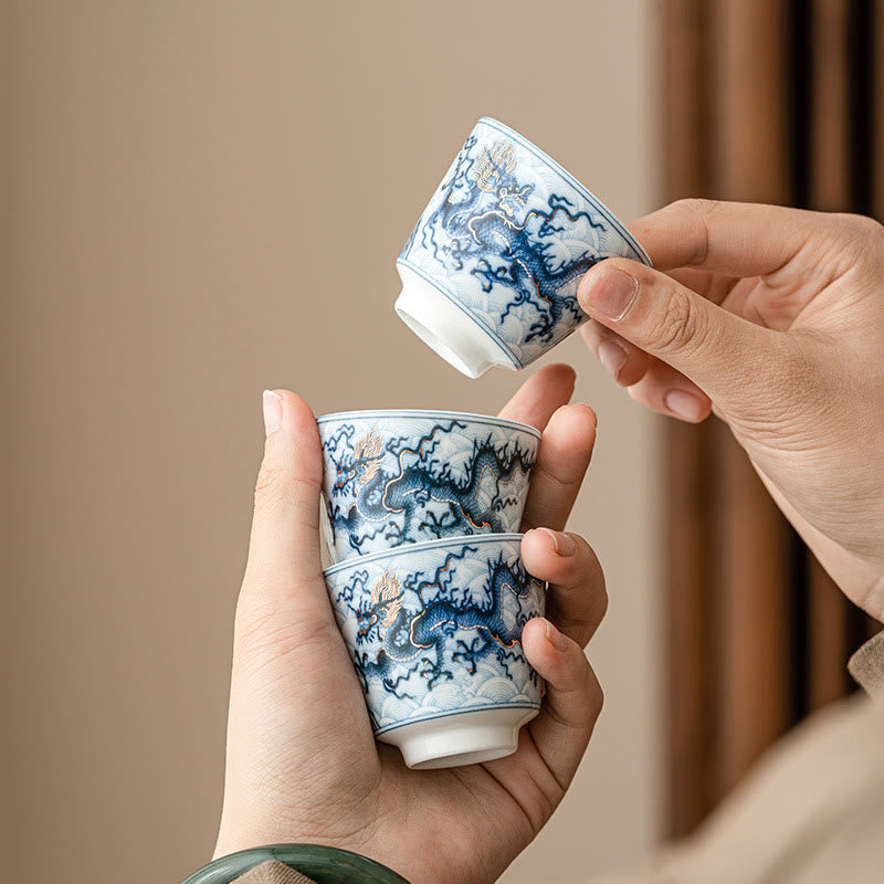 Blue & White Dragon Ceramic Teacup – three cups held in hands, five-clawed imperial dragon, heritage