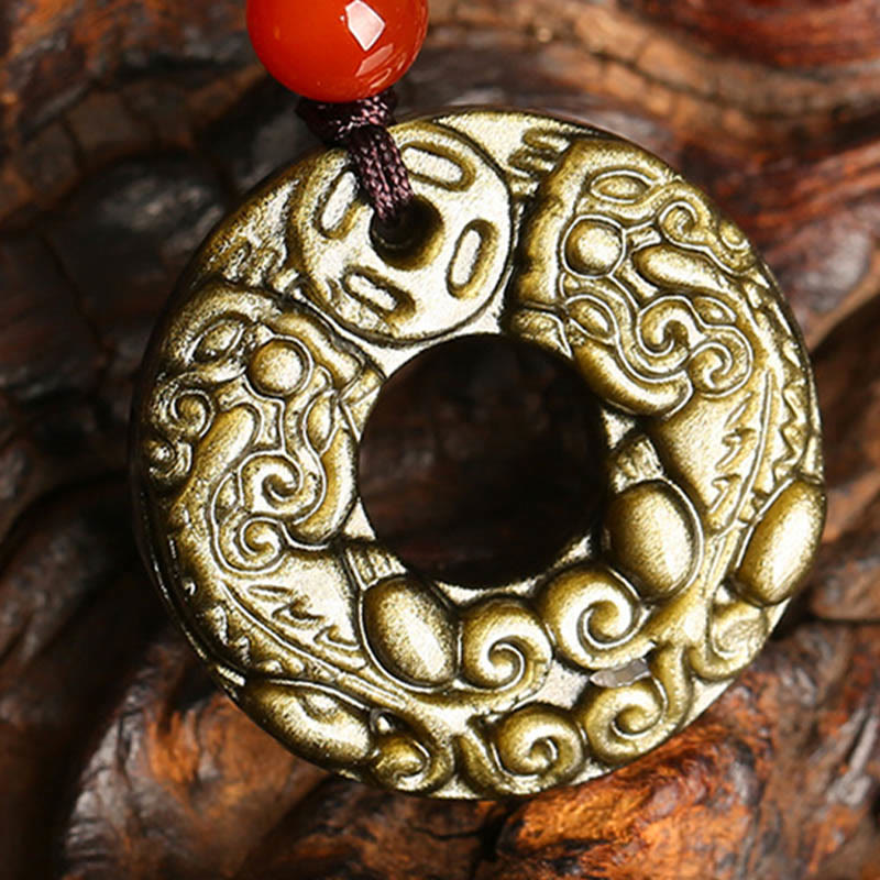 Peace Buckle PiXiu Necklace – Close-up of carved gold sheen obsidian PiXiu disc on wooden root, prosperity talisman