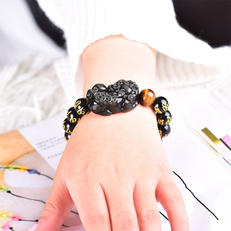 Obsidian PiXiu Rainbow Obsidian Wealth Bracelet – Black obsidian PiXiu bracelet worn on woman's wrist