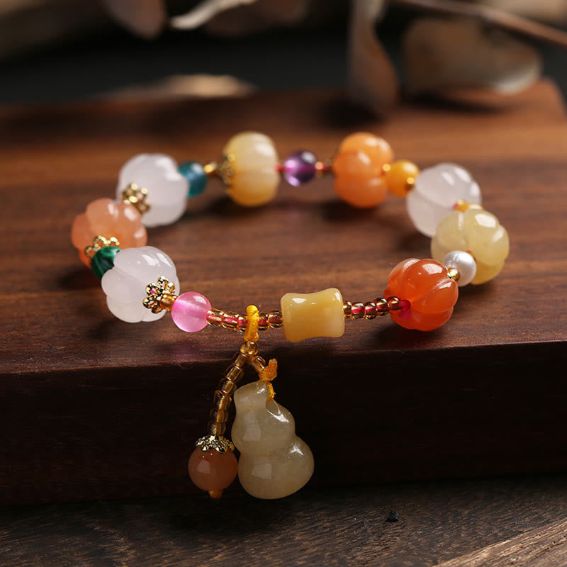 Golden Silk Jade Gourd Bracelet – Colorful jade beads with gourd charm on dark wood