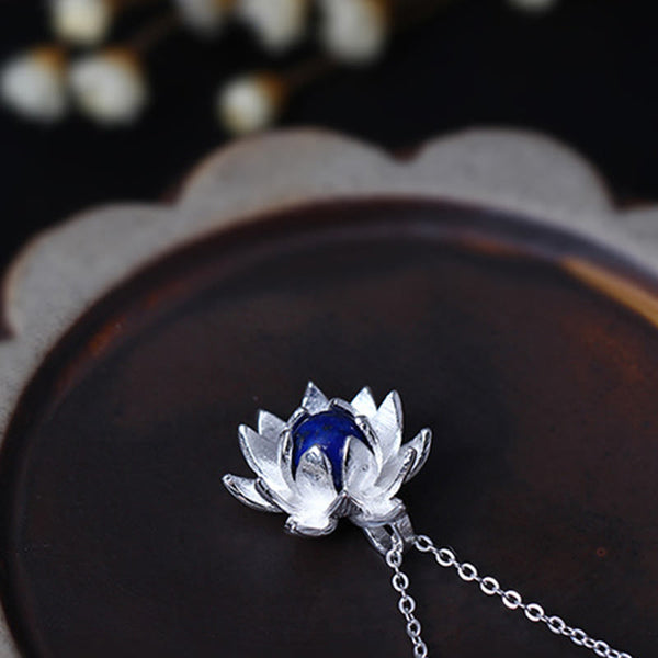 Lapis Lazuli Lotus Necklace - low angle view of silver lotus pendant with blue stone, artisan silver jewelry