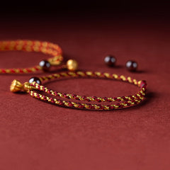 Red Gold Rope Lotus Braid Bracelet - side angle showing adjustable knot and stone bead, cord jewelry