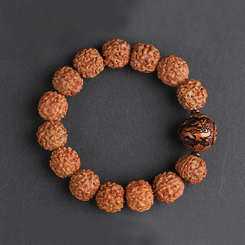 Rudraksha PiXiu Bracelet – Circle layout on dark gray surface with carved center bead, top view