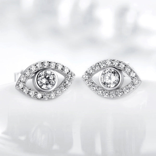Sterling Silver Evil Eye Stud Earrings on Reflective White Surface, Clear Crystal Eye Design