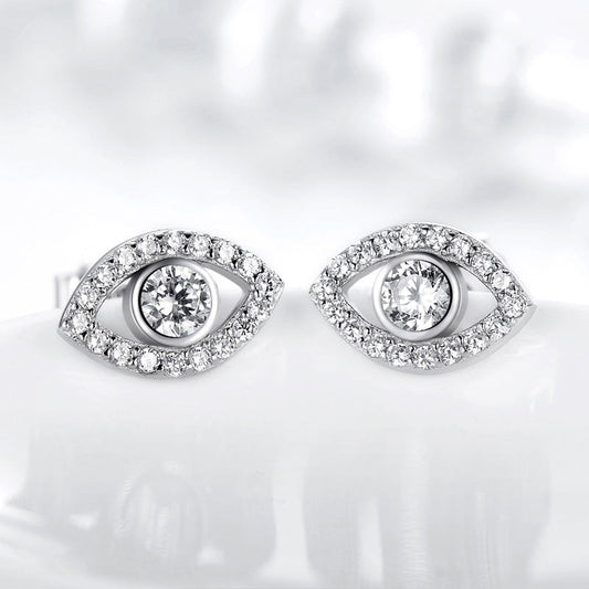 Sterling Silver Evil Eye Stud Earrings on Reflective White Surface, Clear Crystal Eye Design