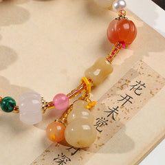 Golden Silk Jade Gourd Bracelet – Close-up jade pumpkin beads, gourd on calligraphy