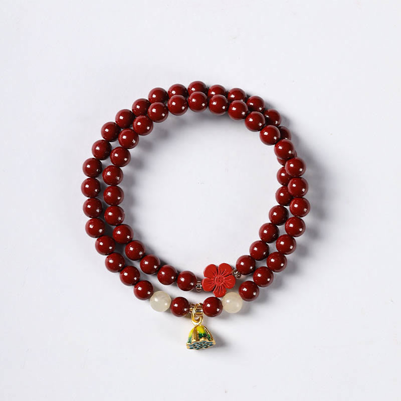 Cinnabar Lotus Bracelet – flat lay on white background with carved flower and lotus pod charm