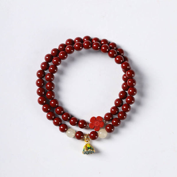 Cinnabar Lotus Bracelet – flat lay on white background with carved flower and lotus pod charm