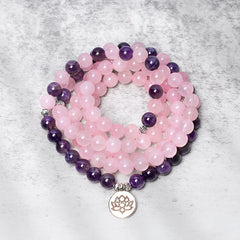 Rose Quartz Amethyst Lotus Bracelet – wrapped mala beads with silver lotus pendant, coiled flatlay