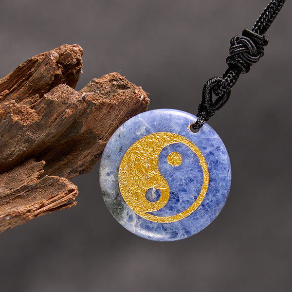 Yin Yang Crystal Necklace – Blue sodalite pendant with gold yin-yang inlay, natural stone with white marbling, polished finis