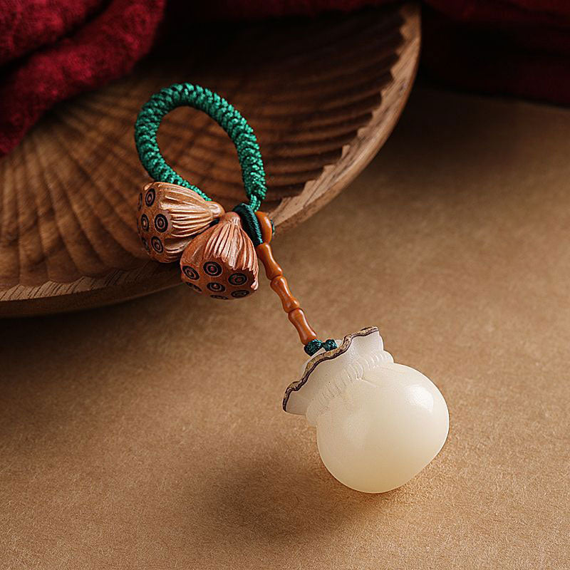 Bodhi Seed Peach Wood Lotus Keychain – Side view featuring copper lotus pods, jade fortune pouch and amber bamboo beads on green cord