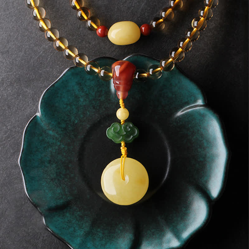 Citrine Mala Bracelet – Citrine mala beads draped on teal ceramic lotus dish, pendant detail