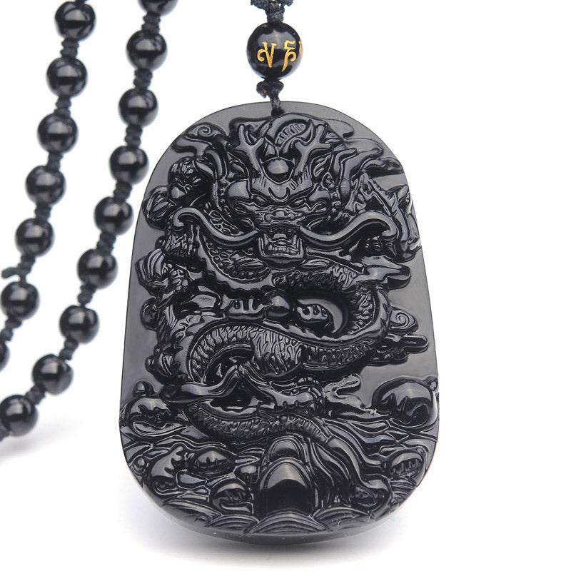 Black Obsidian Dragon Pendant – Front-facing relief dragon on white studio backdrop, protective
