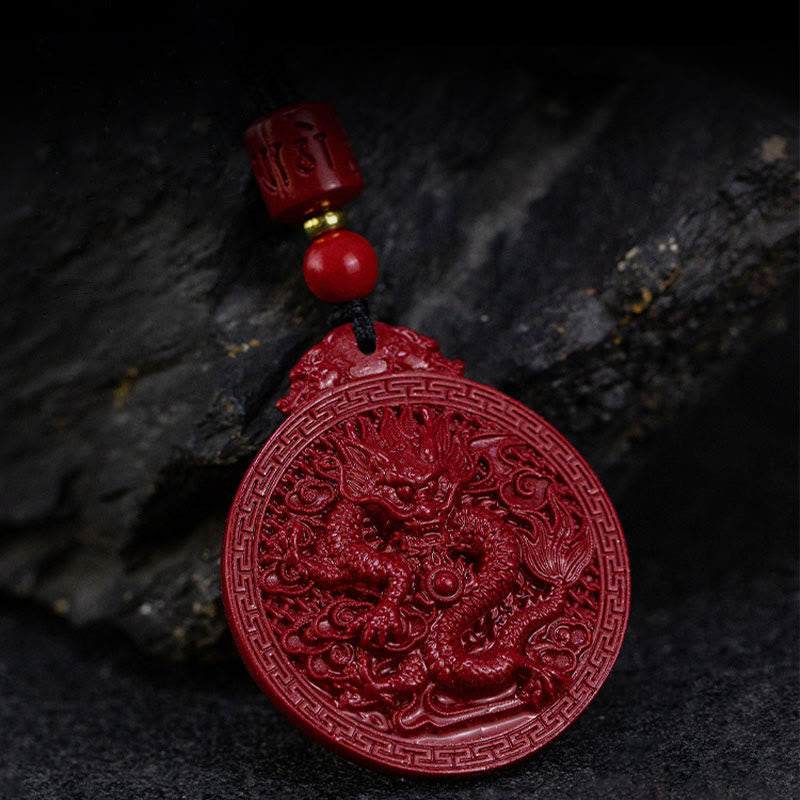 Cinnabar Dragon Pendant – Dramatic lit dragon amulet with cloud motifs on dark stone, Mysterious