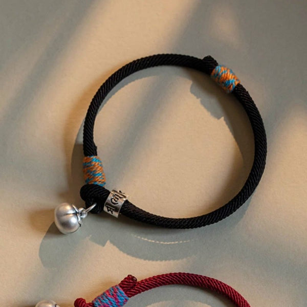Om Mani Padme Hum Bracelet - Black braided cord with turquoise orange wrap and engraved mantra cylinder