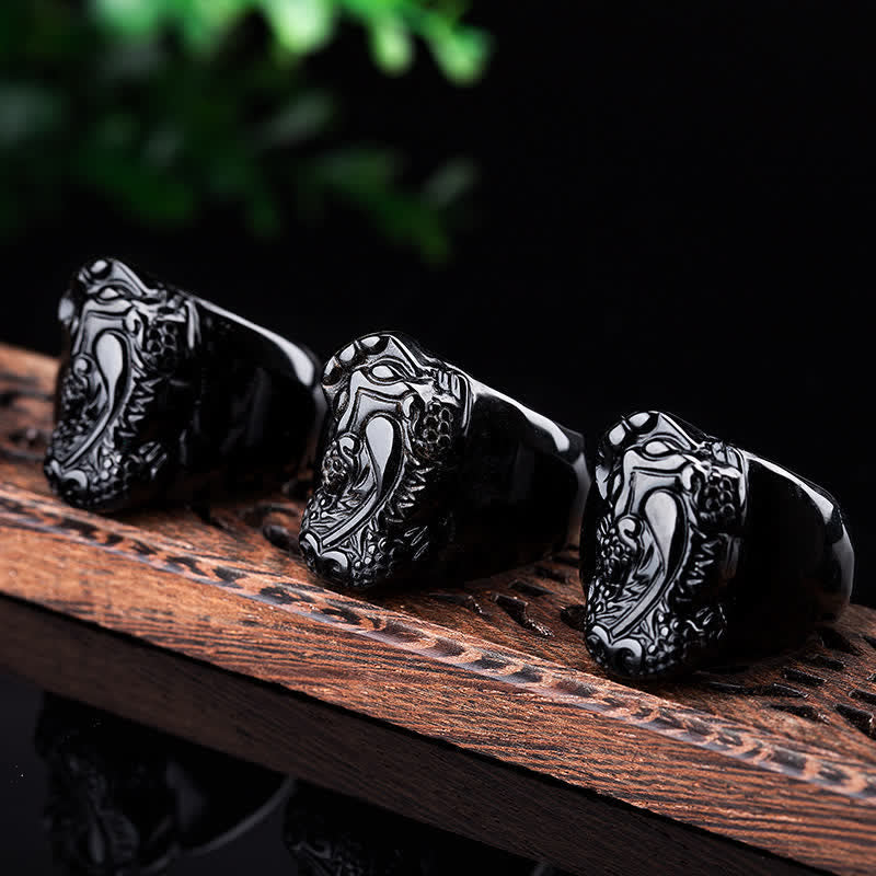 FengShui PiXiu Strength Ring – Three black obsidian pixiu rings on carved wood, men's feng shui ring