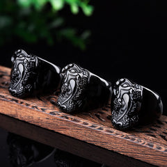 FengShui PiXiu Strength Ring – Three black obsidian pixiu rings on carved wood, men's feng shui ring