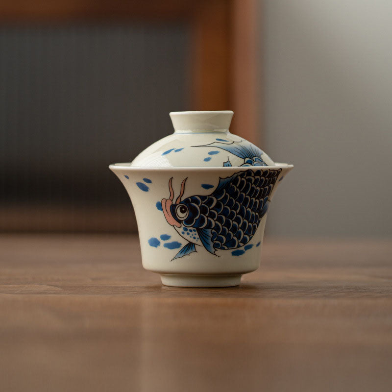 Koi Fish Gaiwan – with steaming tea showing heat rising, ceramic teacup