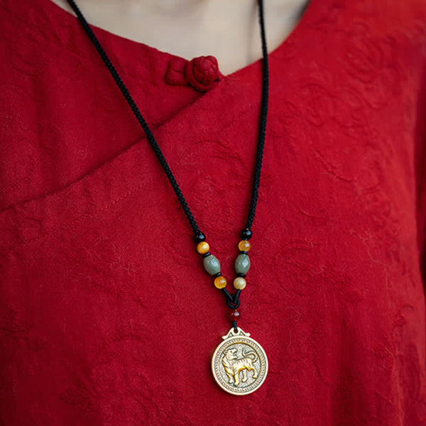 12 Chinese Zodiac Fortune Necklace Pendant – Tiger zodiac necklace worn on red silk garment with mandarin collar and frog button, antique gold tiger medallion with meander border, jade and carnelian beaded black cord, traditional Chinese cultural styling