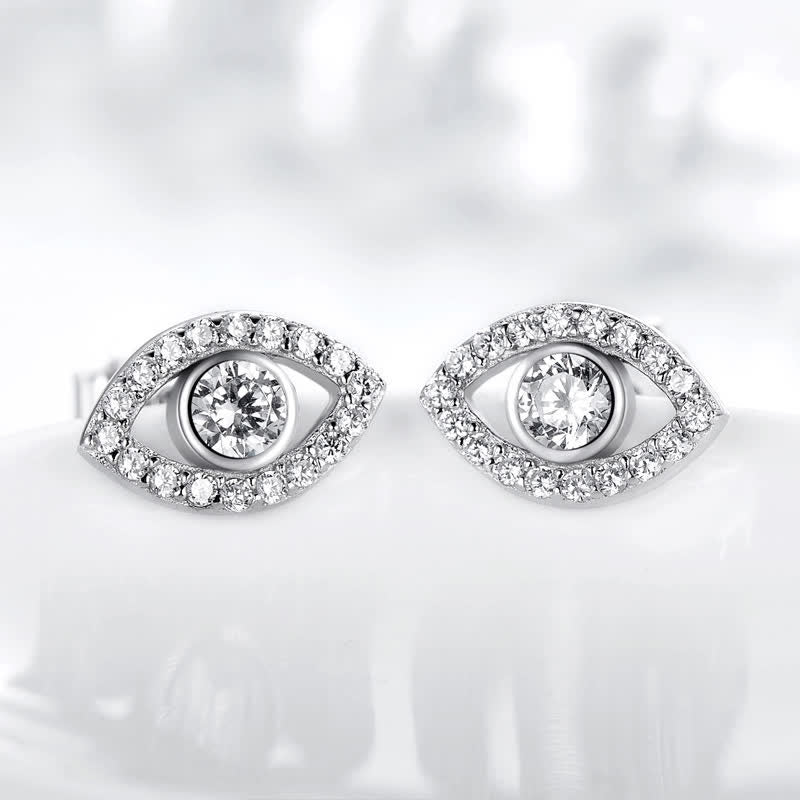 Evil Eye Bundle – Silver pavé evil eye stud earrings on soft white background, crystal sparkle detail