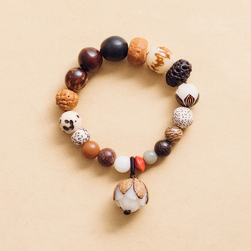 Bodhi Seed Lotus Bracelet – Top-down view of mixed seed beads with carved lotus pendant, wisdom mala