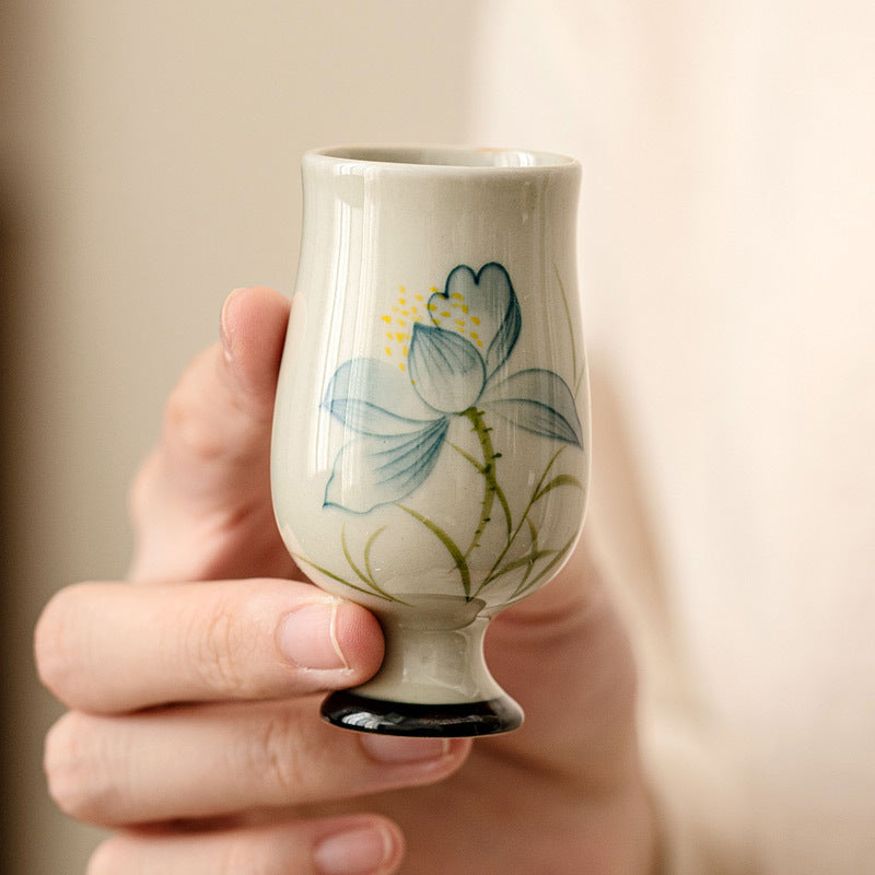 Hand Painted Lotus Tea Cup – stemmed lotus cup on fluted dish with teapot spout, tea ceremony setting, layered