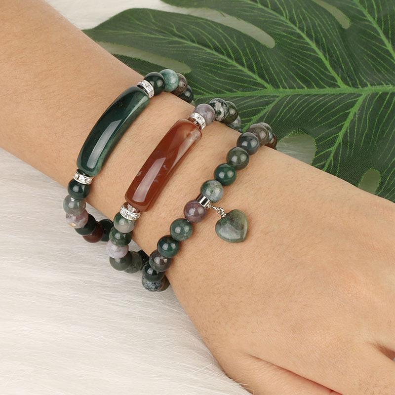 Natural Multi-Stone Love Heart Healing Bracelet - Three Indian Agate bracelets stacked on wrist with green beads, reddish-brown bar accent, and heart charm