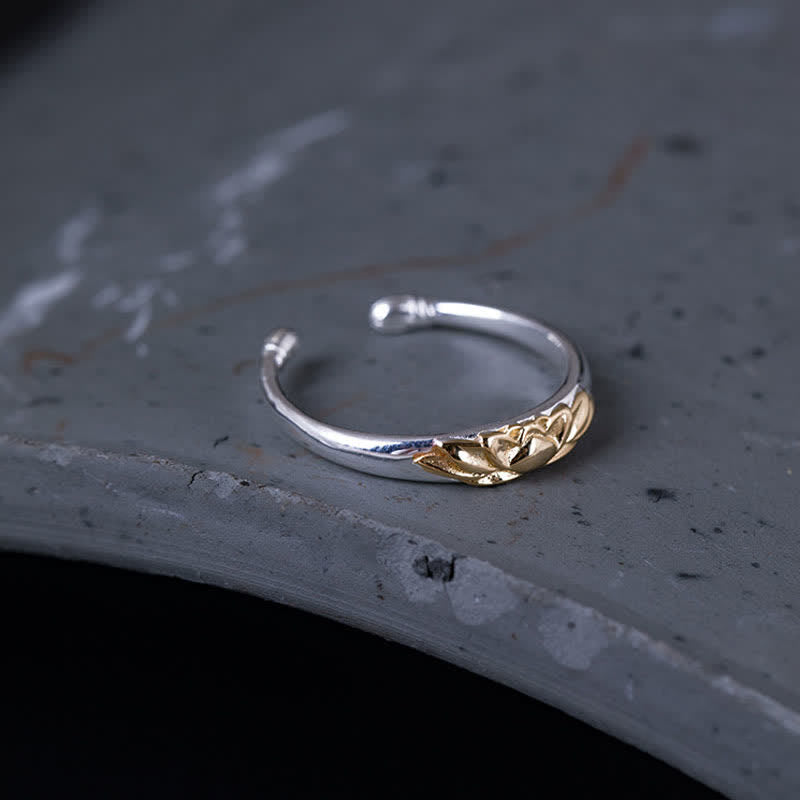 925 Sterling Silver Lotus Ring – Side angle of adjustable lotus ring on gray ceramic dish, two-tone ring