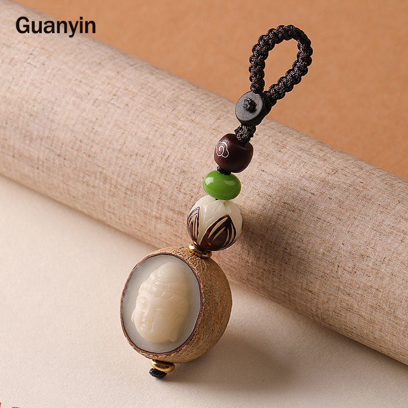 Bodhi Seed Blessing Keychain - Guanyin head carving nestled inside natural seed pod with silver inlay cloud bead, compassion