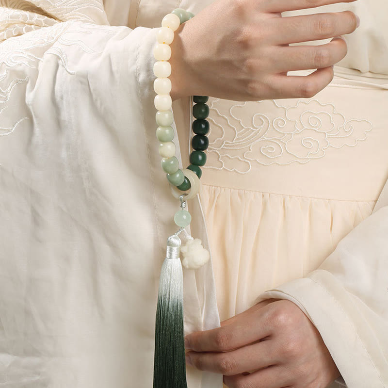 Bodhi Seed Lotus Wisdom Wrist Mala – Green gradient prayer bracelet worn on wrist with Hanfu, traditional Chinese style spiritual beads