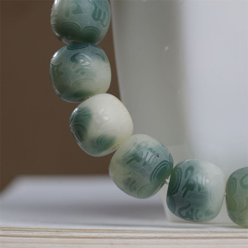 Bodhi Seed Om Mani Padme Hum Bracelet – Diagonal close-up of barrel beads with wave motifs, Buddhist prayer beads