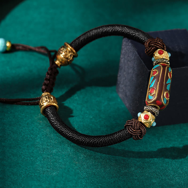 Tibetan Turquoise Om Mani Padme Hum Braided Bracelet – Black cord with turquoise inlay bead on emerald green velvet
