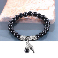 Tree of Life black onyx bracelet with polished black beads, silver-toned tree of life pendant, silver decorative metal accents.