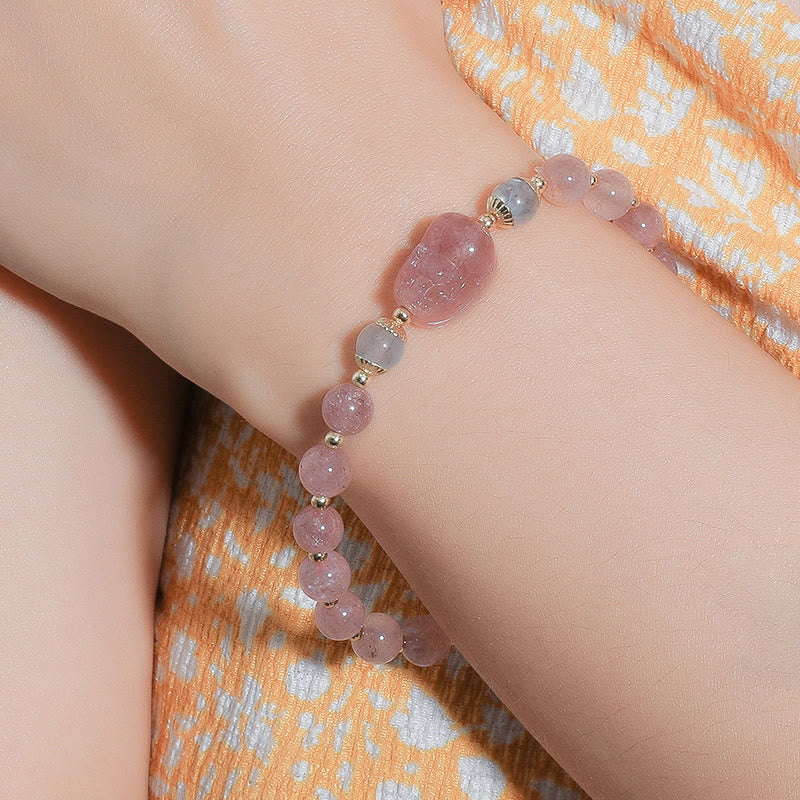 Moonstone Strawberry Quartz Tourmaline Bracelet – Strawberry quartz bracelet with PiXiu worn on wrist, orange dress, healing